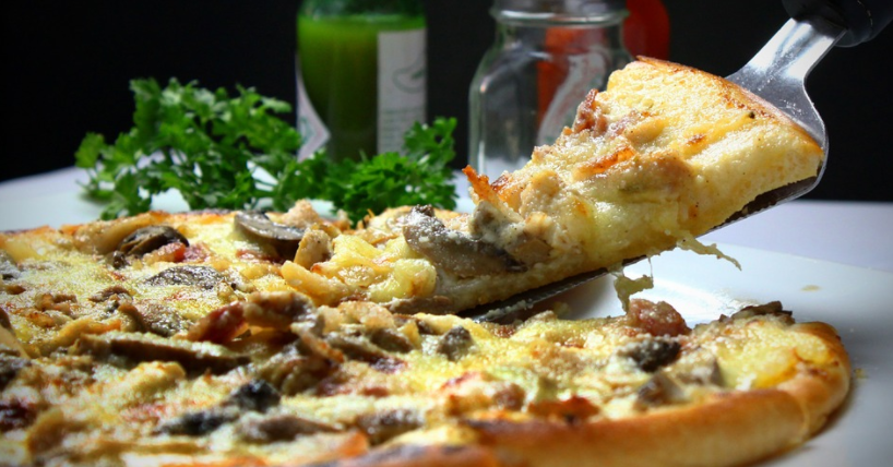 a slice of pizza with mushrooms and cheese