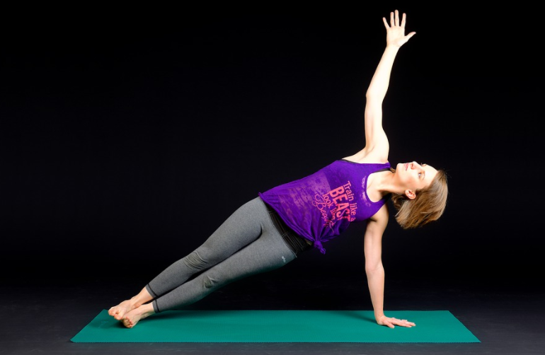 a woman doing yoga on a mat