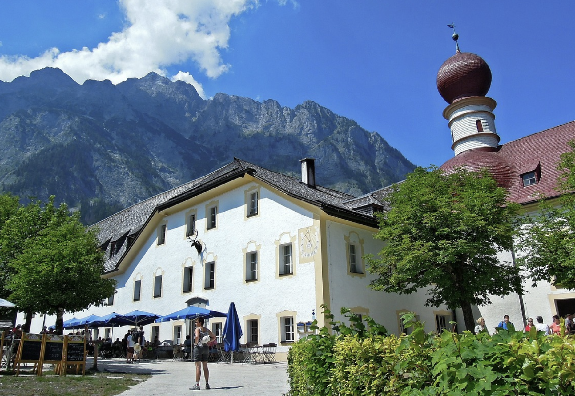 a building with a steeple and a mountain in the background