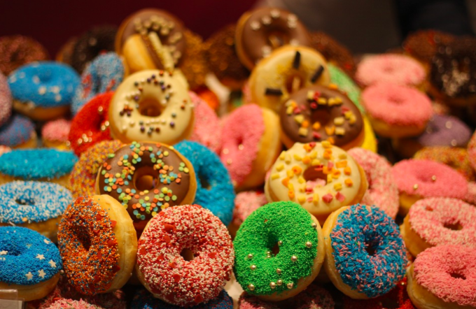 a pile of donuts with sprinkles