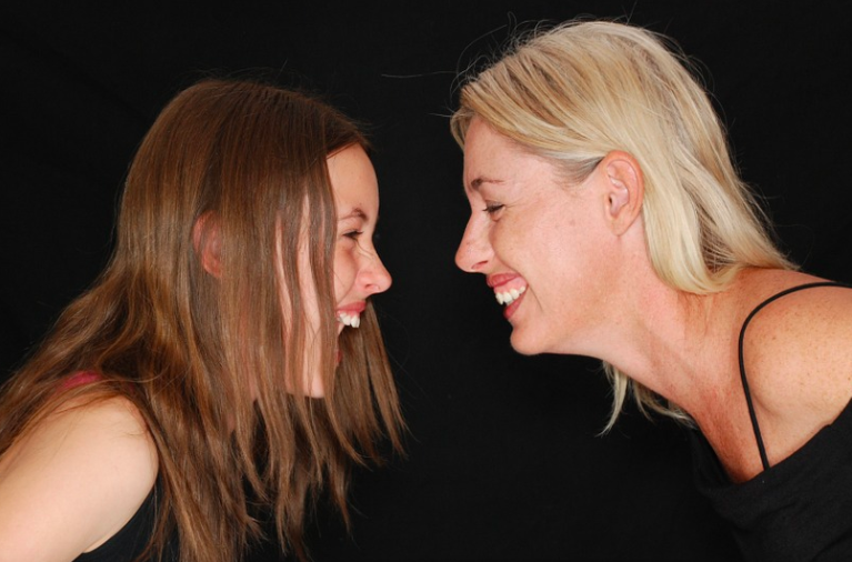 a woman and a girl laughing